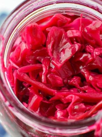 A jar with fermented red cabbage (sauerkraut) inside.