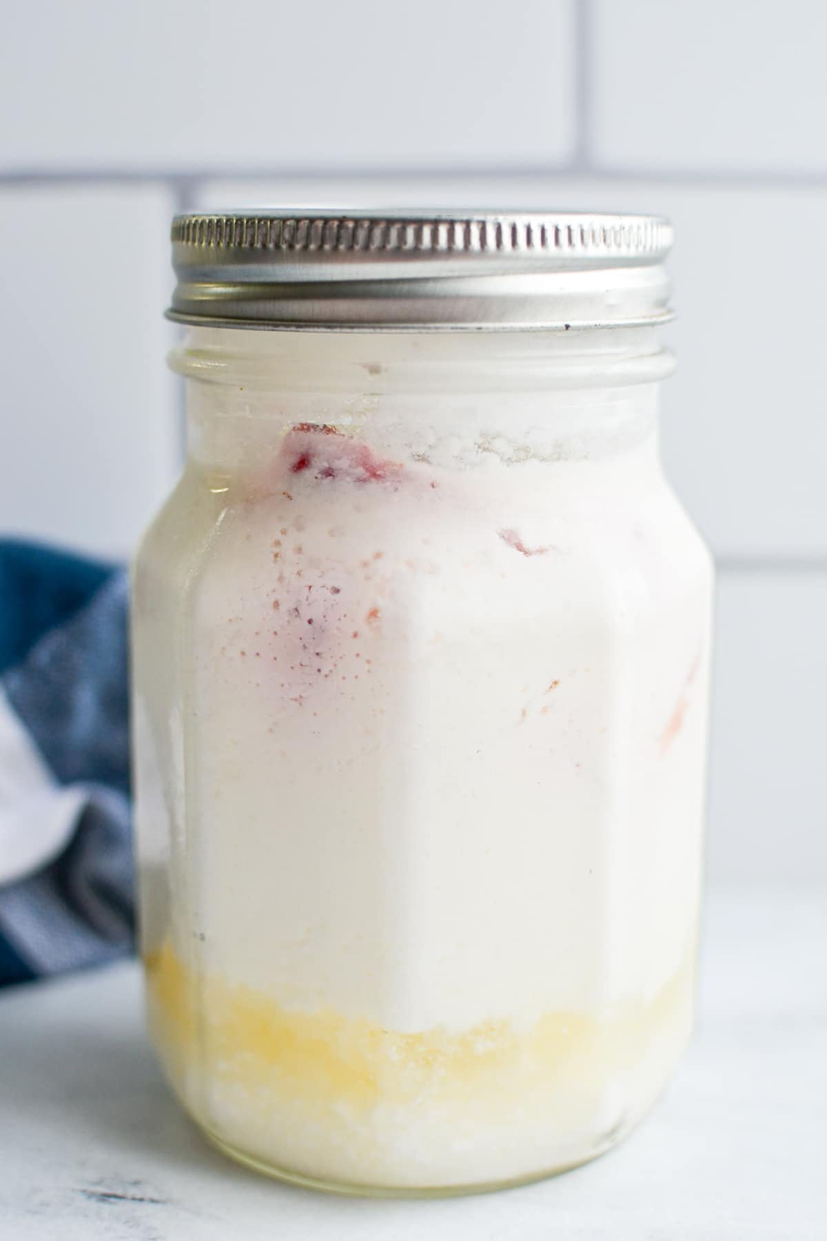 A jar of milk kefir that has been over fermented.