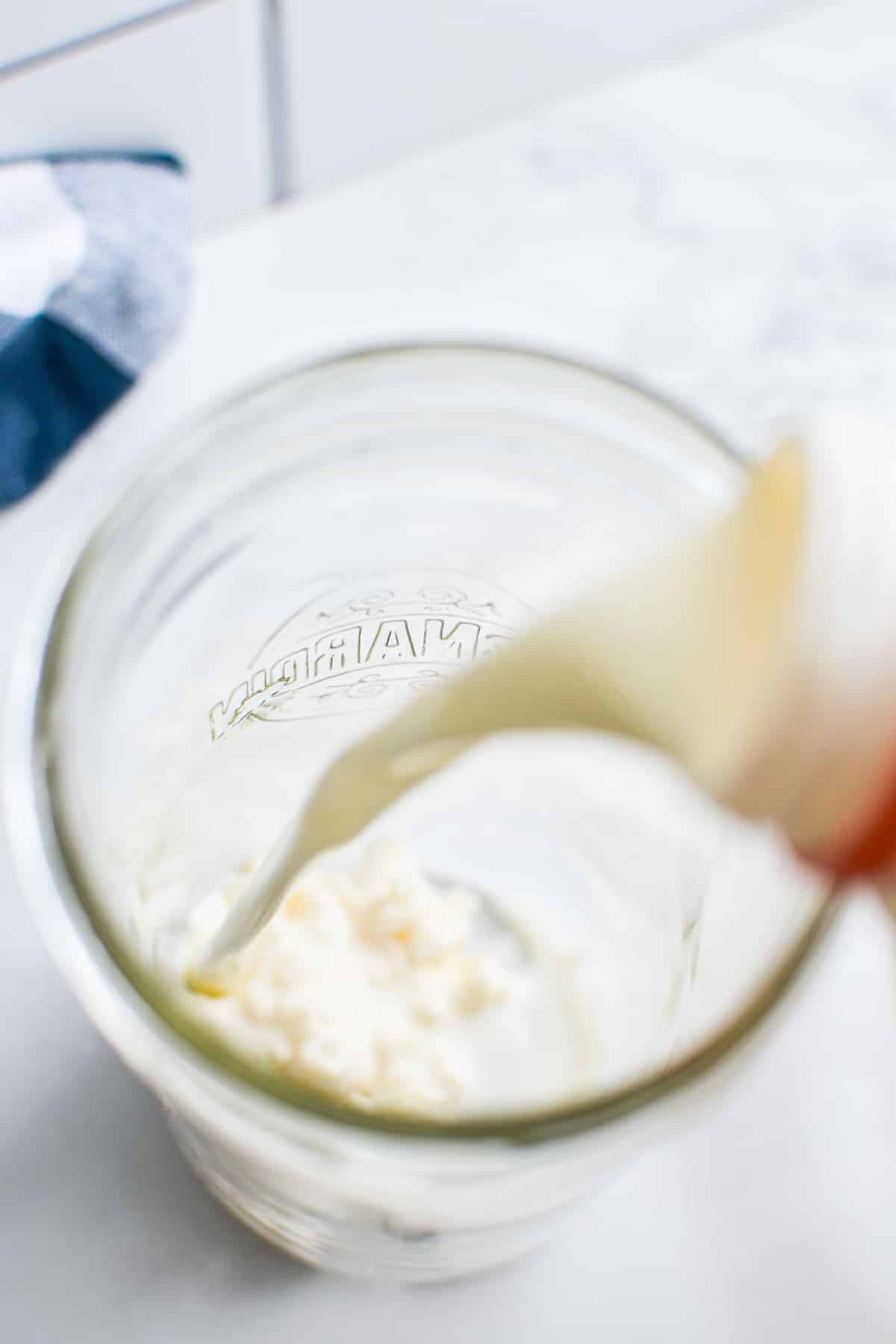 Pouring milk into a jar.