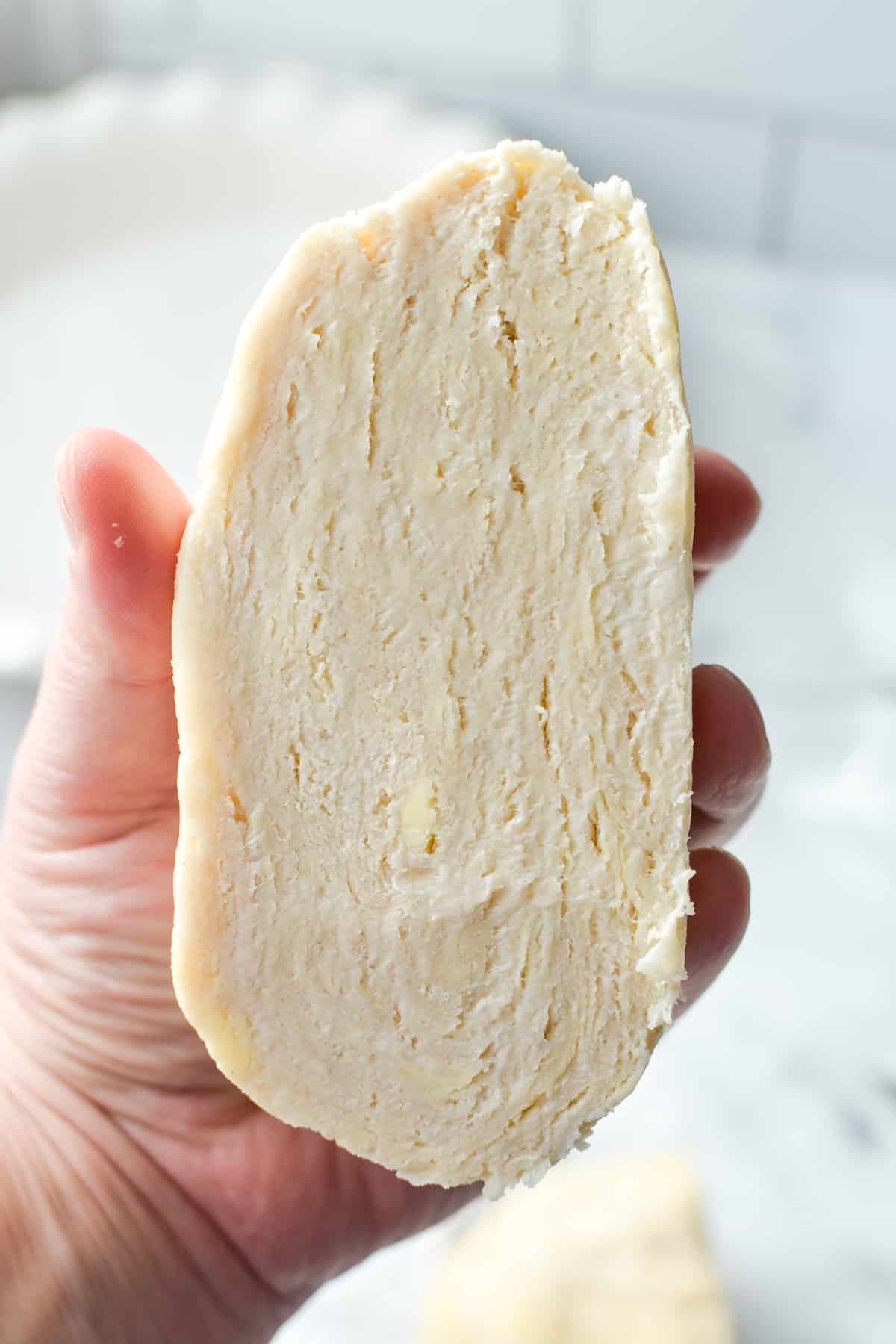 A cross section of a chunk of pie dough, showing the flaky layers.