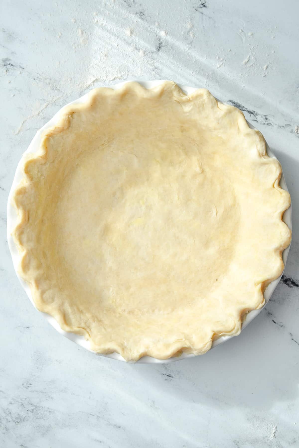 A pie crust with fluted edges.