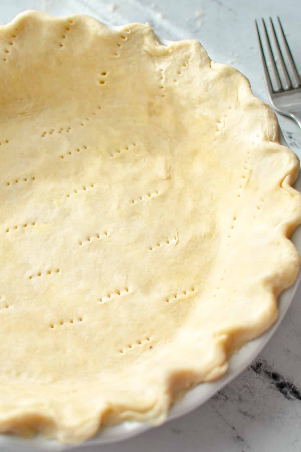 A pie crust with fluted edges.