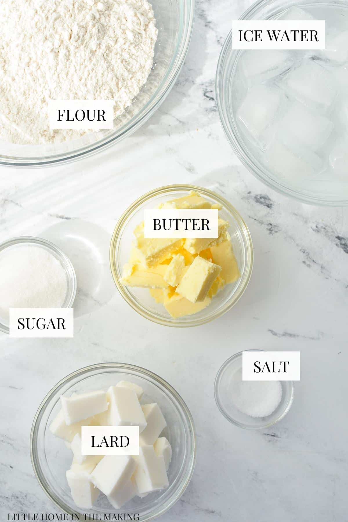 The ingredients needed for making Amish pie crust: flour, butter, lard, salt, sugar and water.