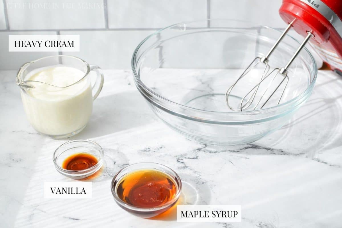 The ingredients needed to make whipped cream: heavy cream, vanilla, and maple syrup.