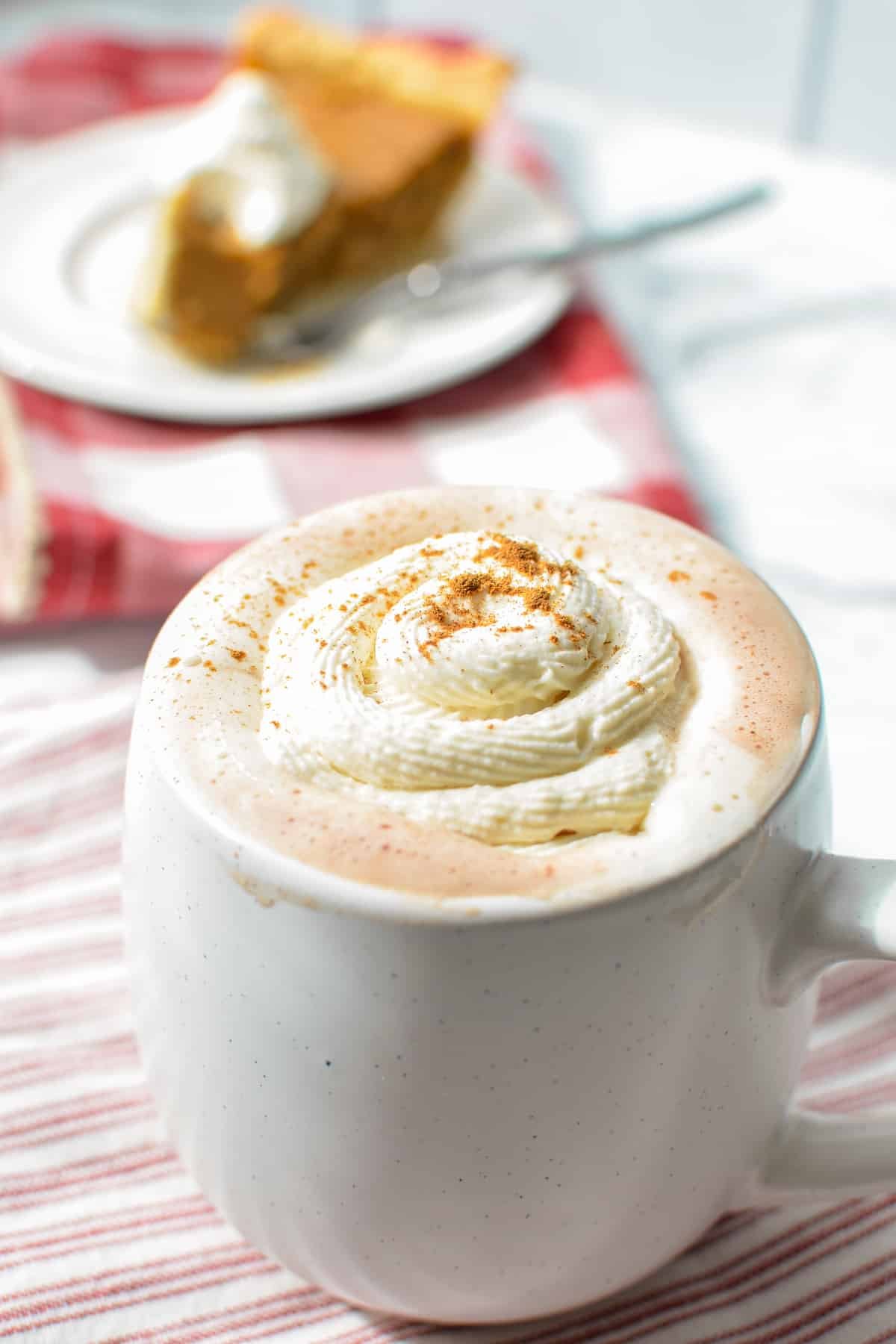 A cup of coffee topped with whipped cream.