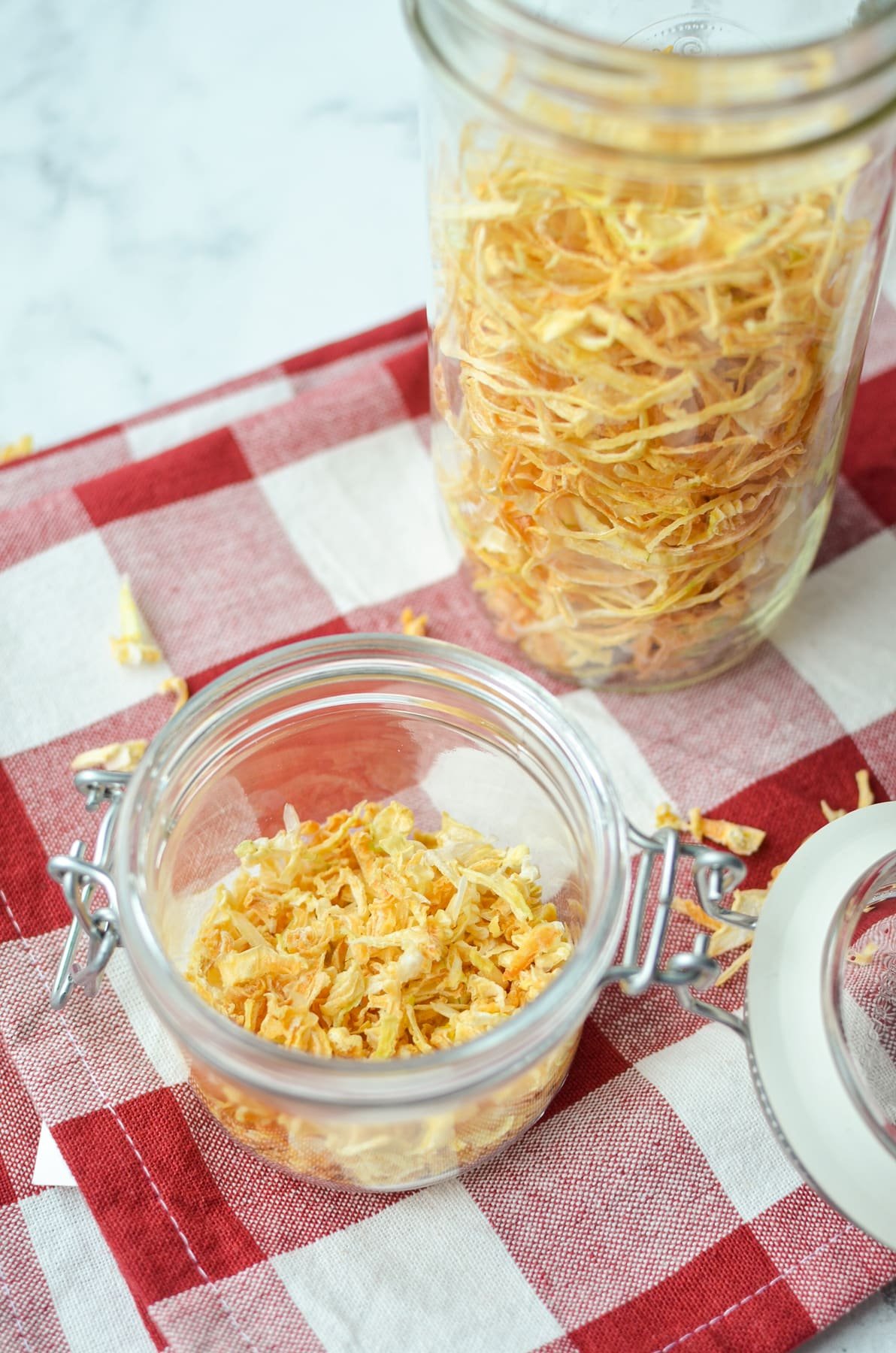 Two jars with dried onion pieces.