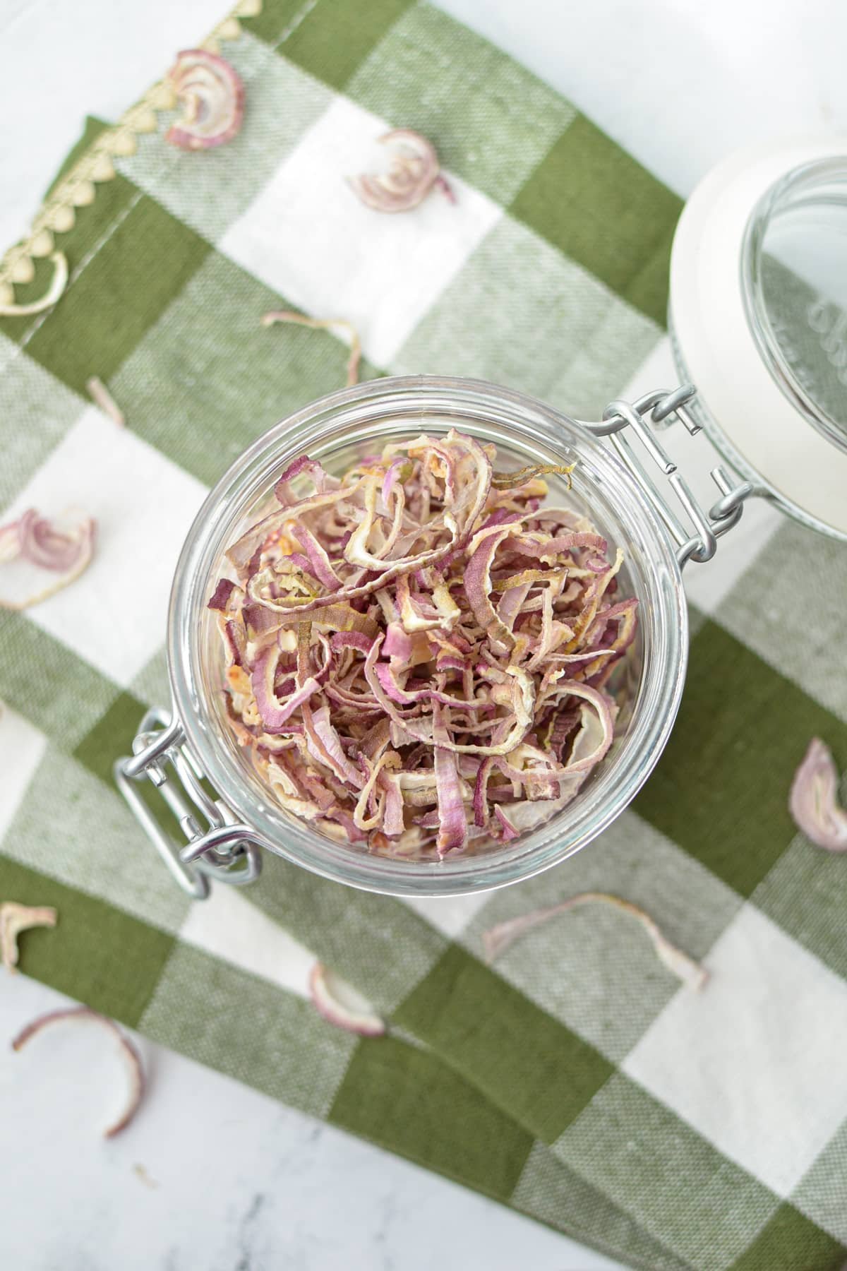 An overhead view of a jar filled with dried shallots.