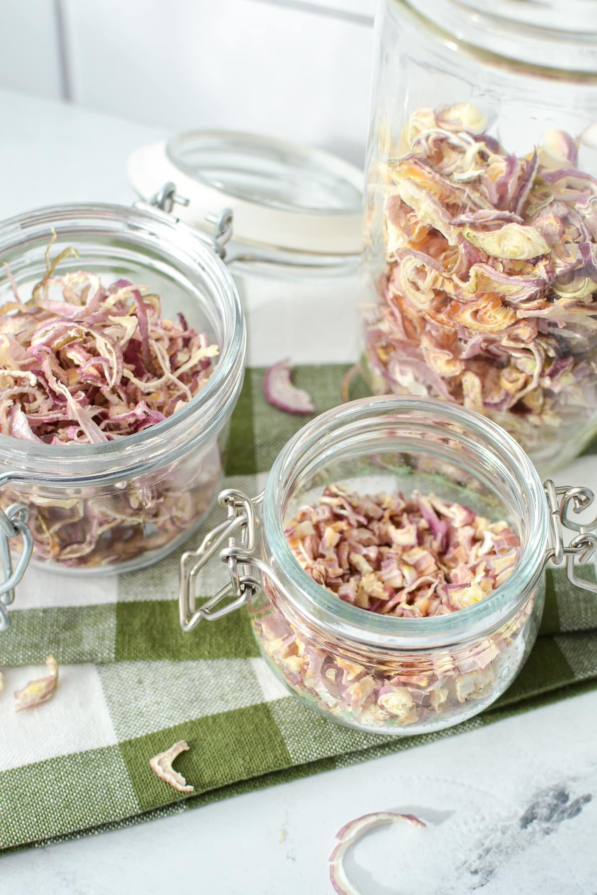 Three jars filled with dried food.