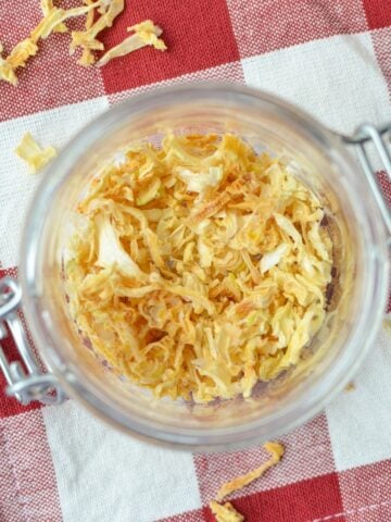 A jar filled with onion flakes.