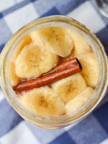 A jar of sliced bananas with cinnamon.