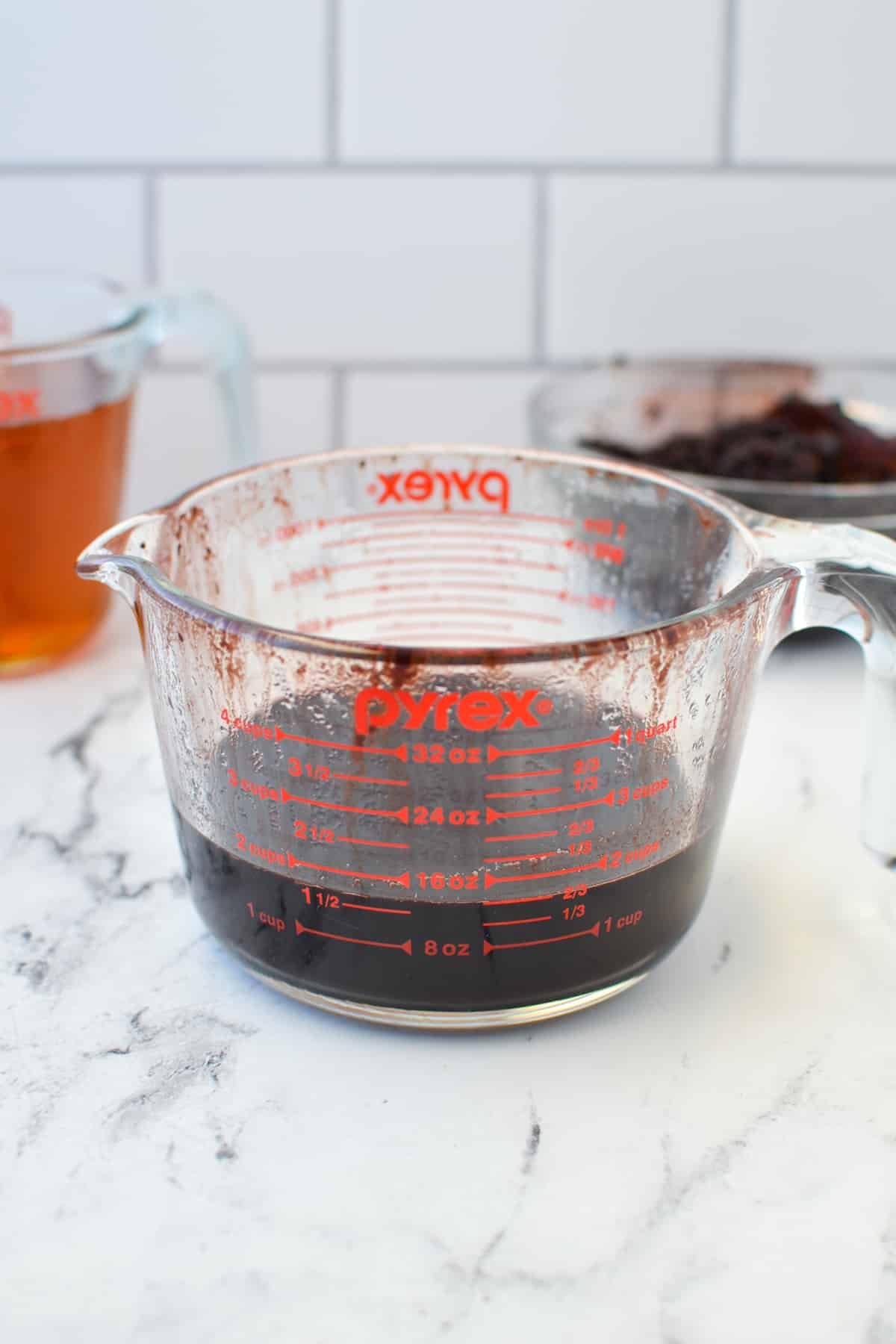 A glass measuring cup filled with liquid.