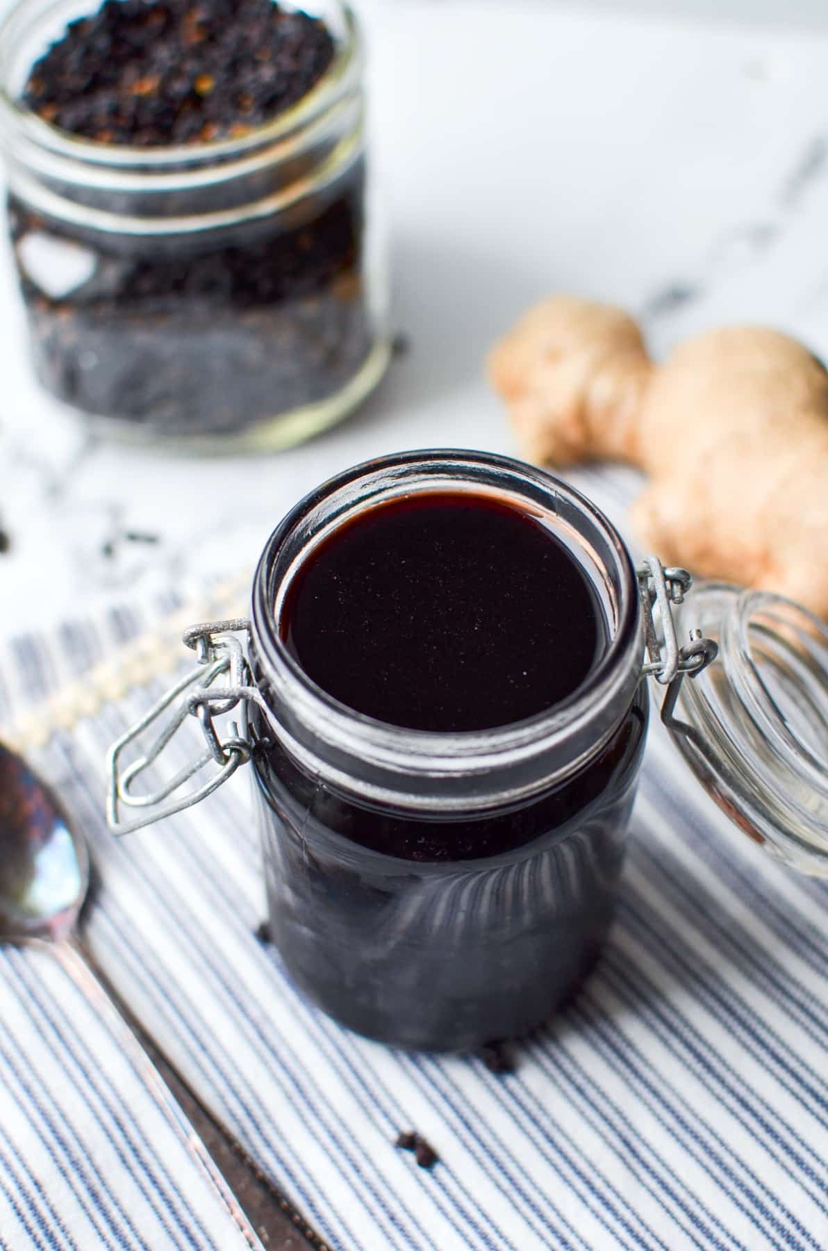 A jar of elderberry syrup on a napkin.