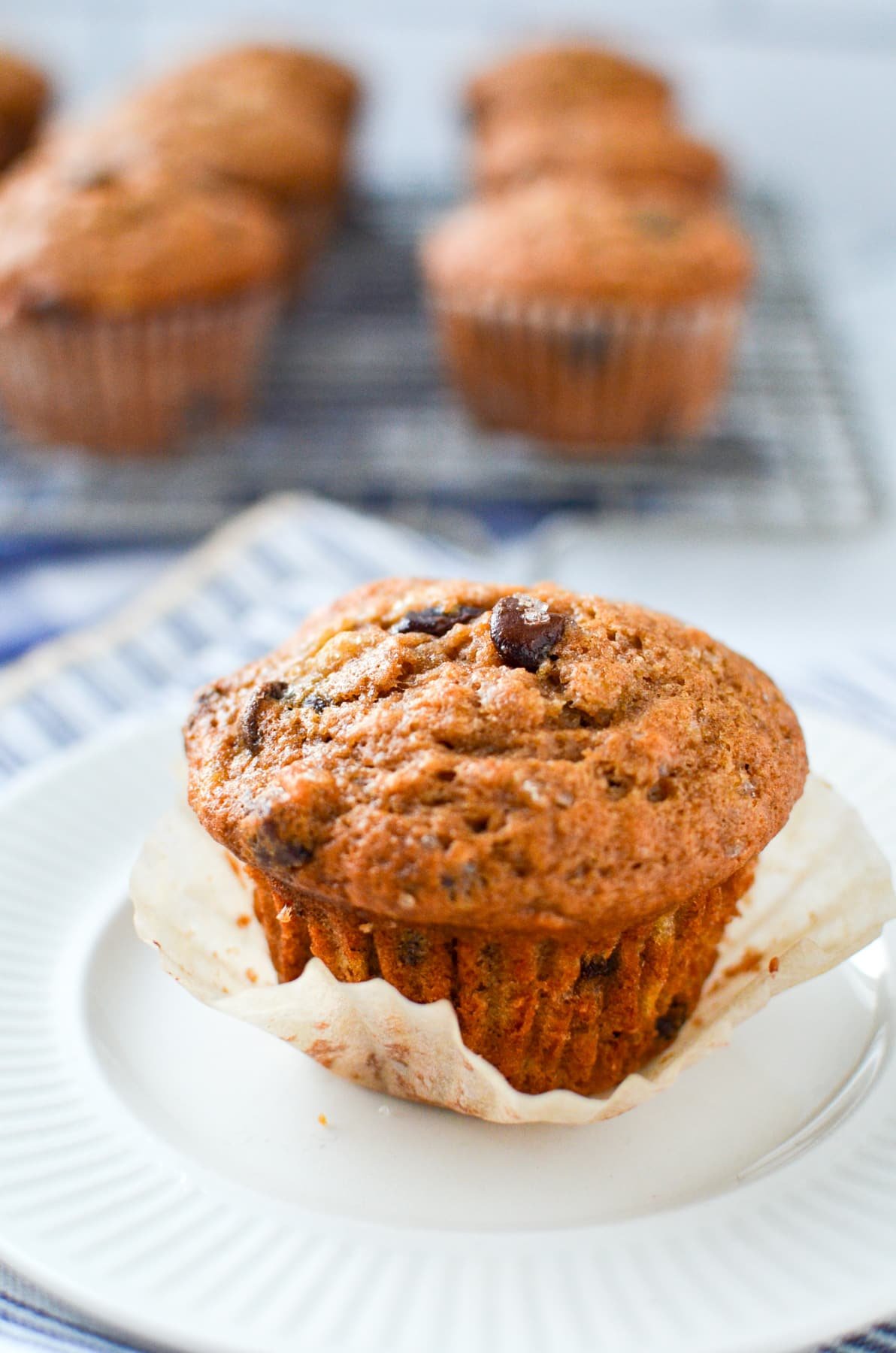 A sourdough banana muffin on a white plate.