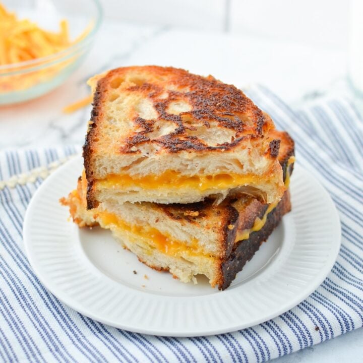 Two slices of grilled cheese stacked on top of one another.