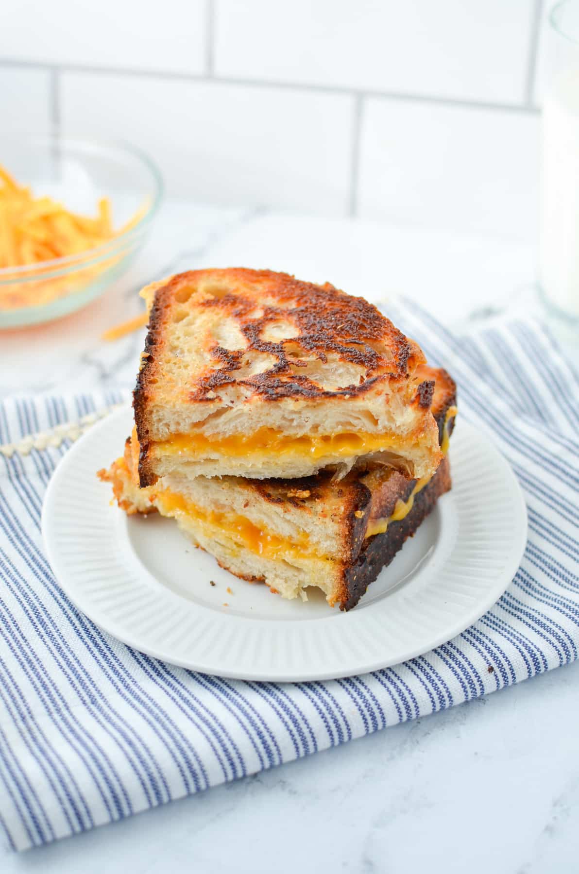 Two halves of a grilled cheese sandwich on a plate.