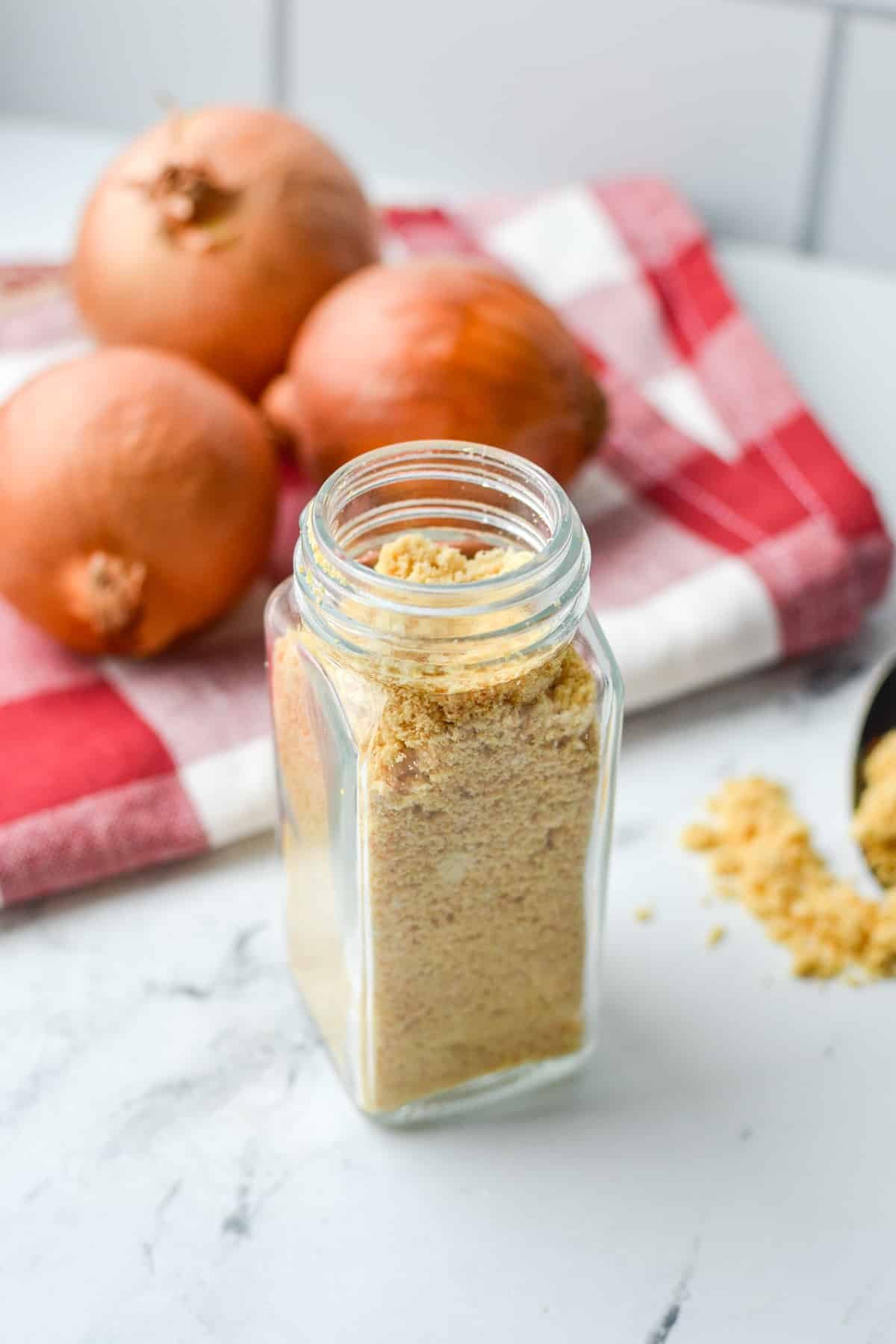 A small spice jar filled with onion powder.