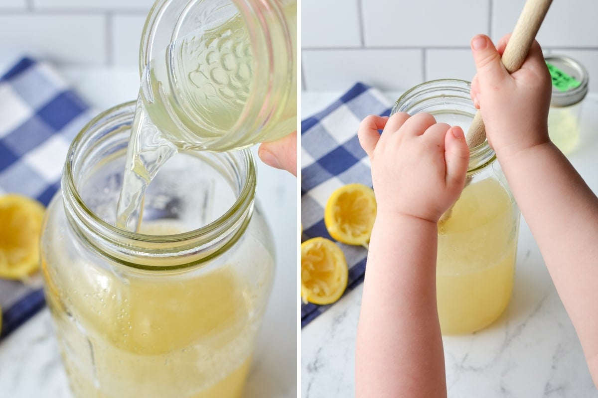 A toddlers hands stirring a large jar of lemonade.