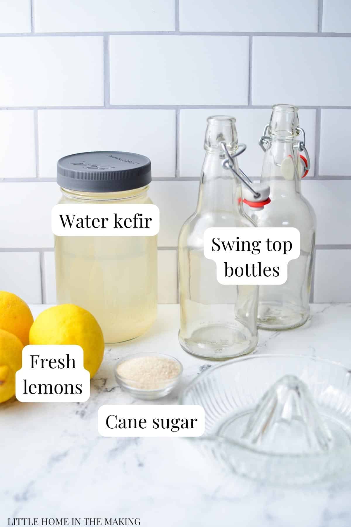 The ingredients needed to flavor water kefir with lemon: water kefir, lemons, and cane sugar.