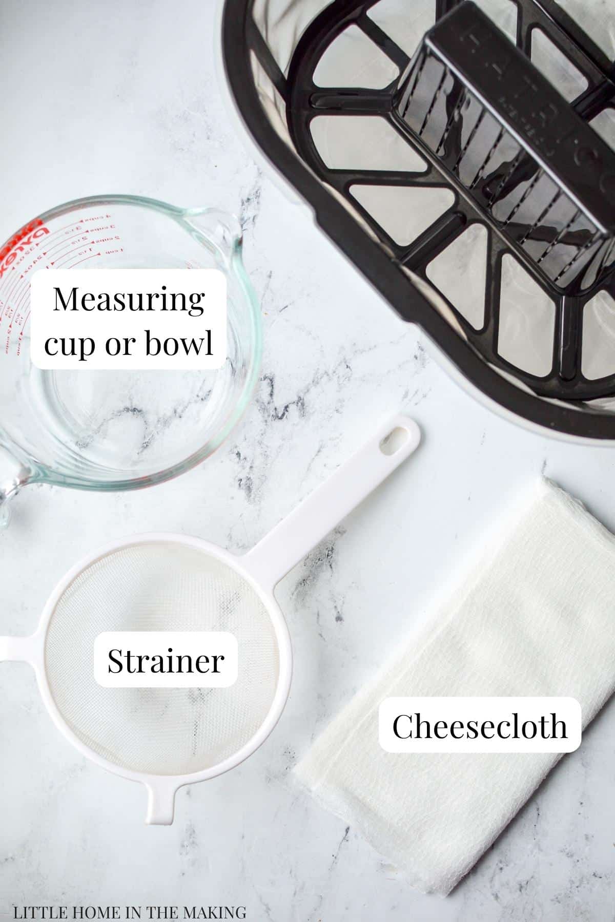 The tools needed to strain yogurt: strainer, cheesecloth, and a bowl or measuring cup.