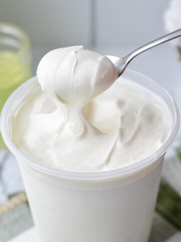 A spoon scooping out a portion of homemade Greek yogurt.