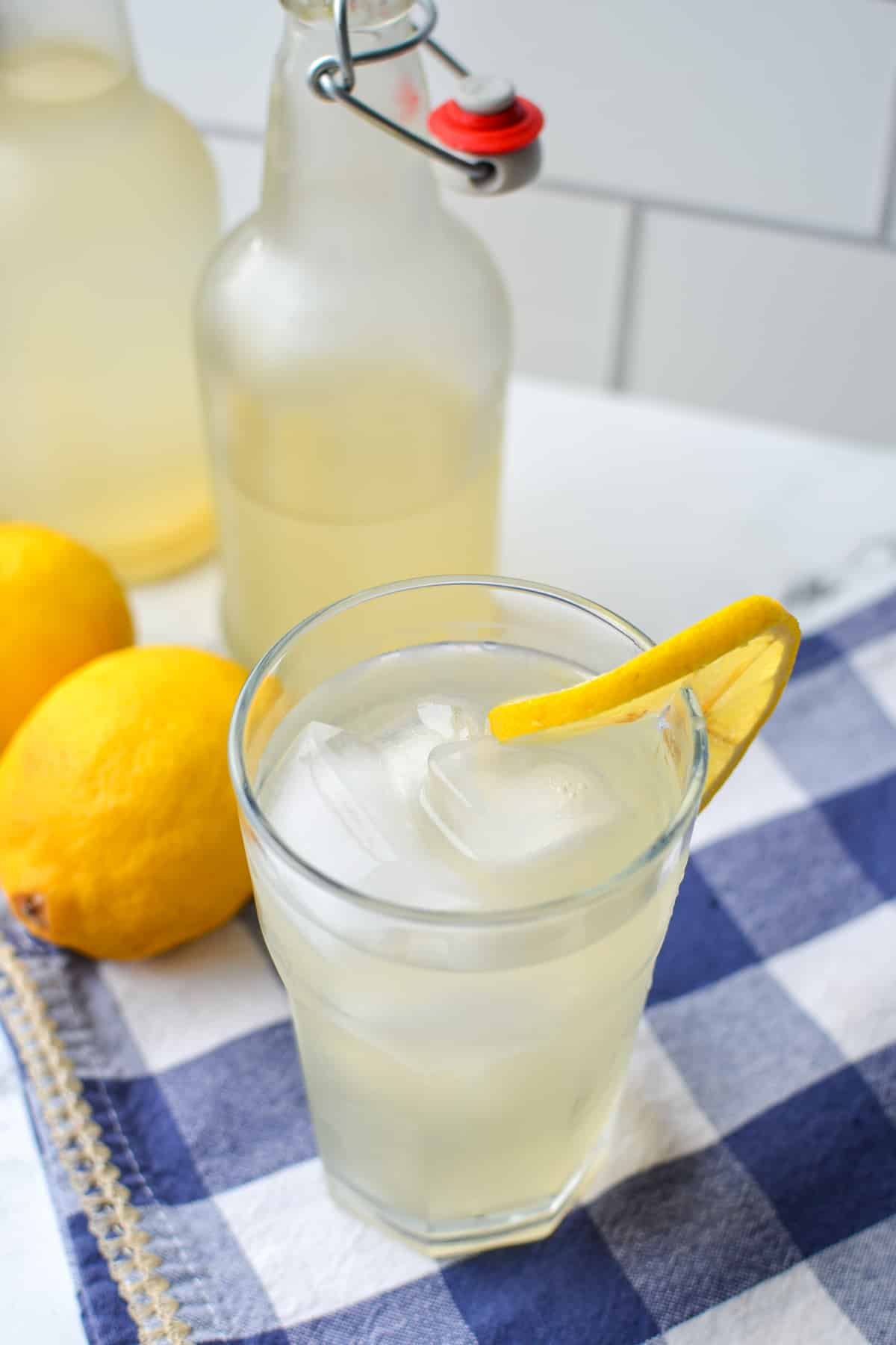 A glass of lemonade with a lemon slice.