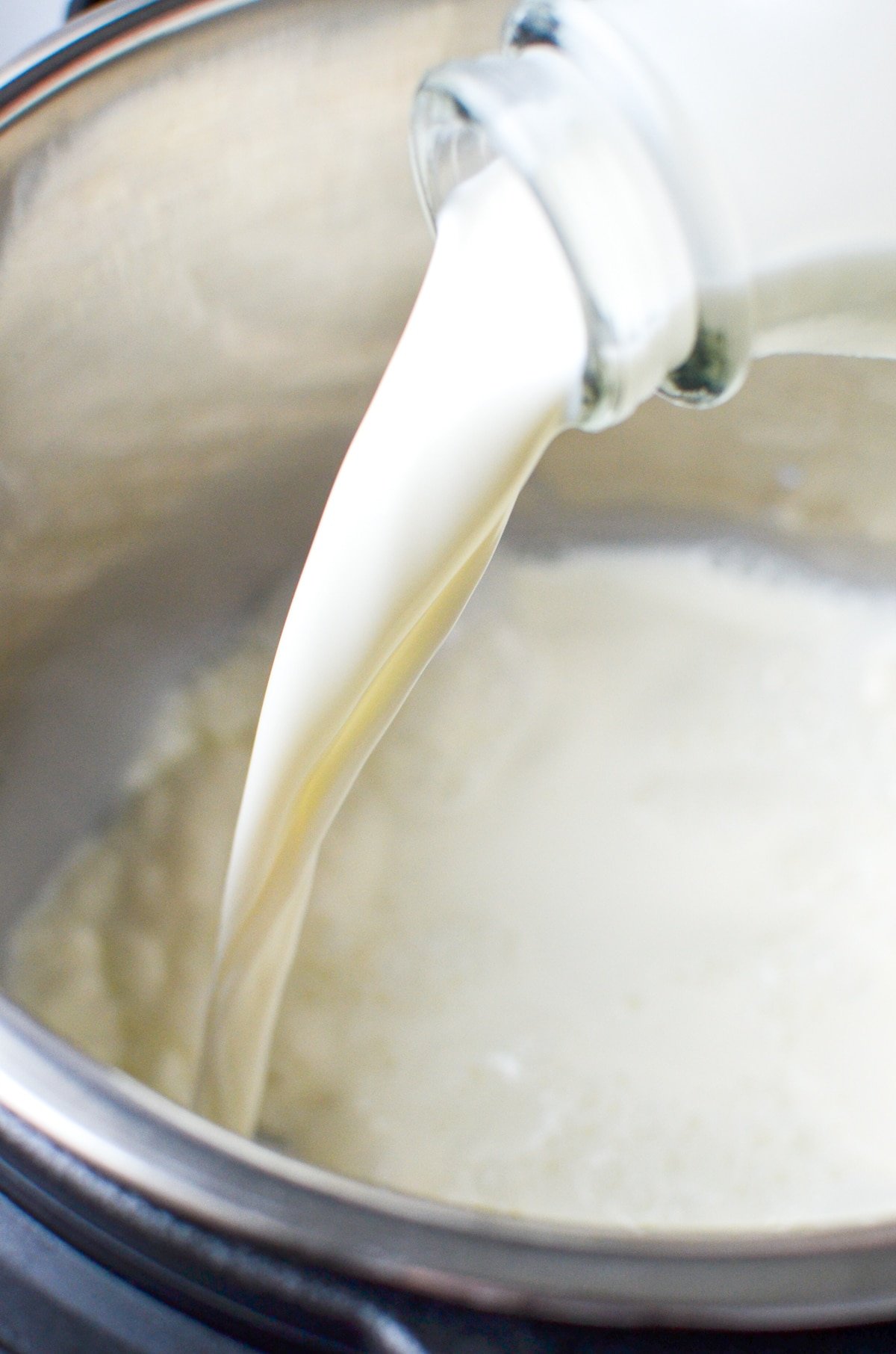 Pouring milk into an Instant Pot.