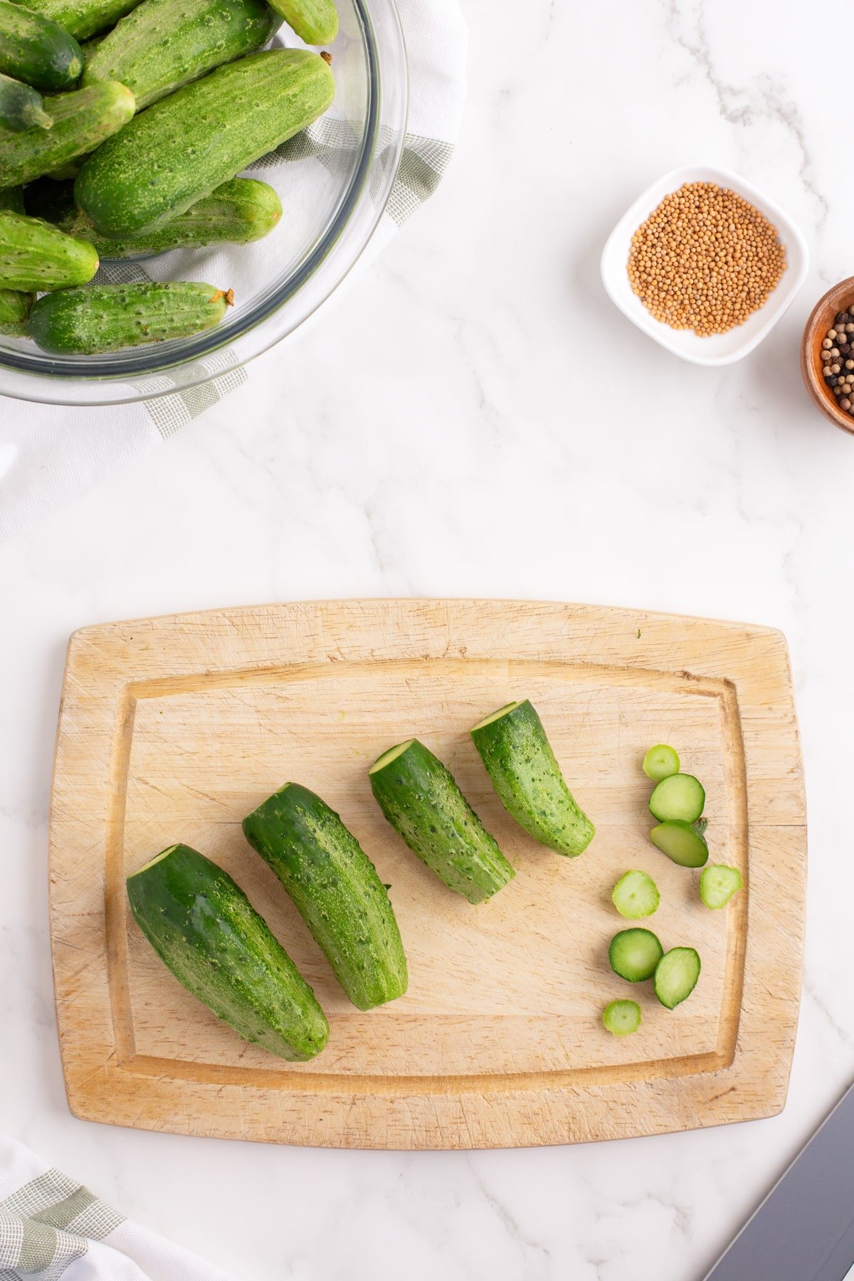 Slicing cucumbers on a cutting board.