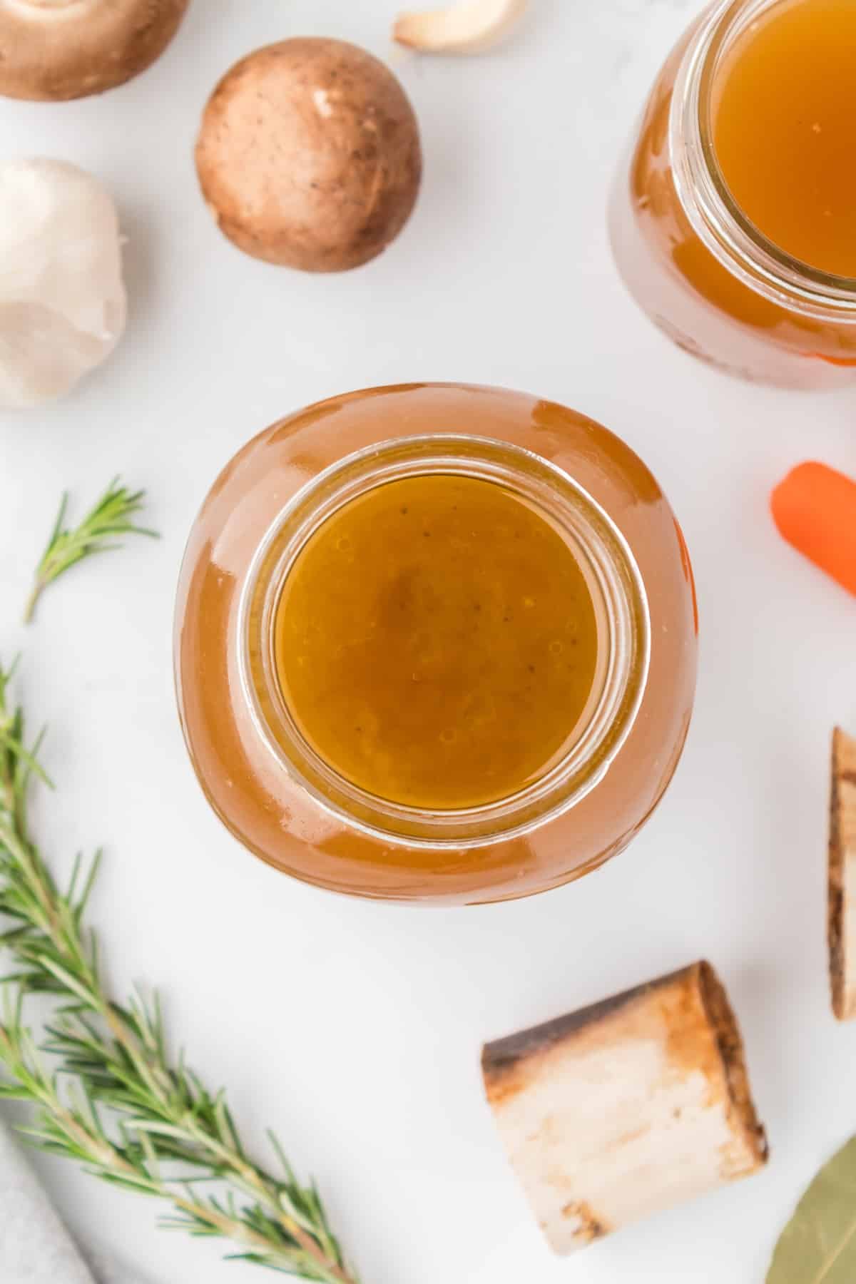 An overhead view of a glass jar filled with homemade broth.