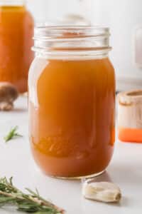 A mason jar filled with homemade beef broth.