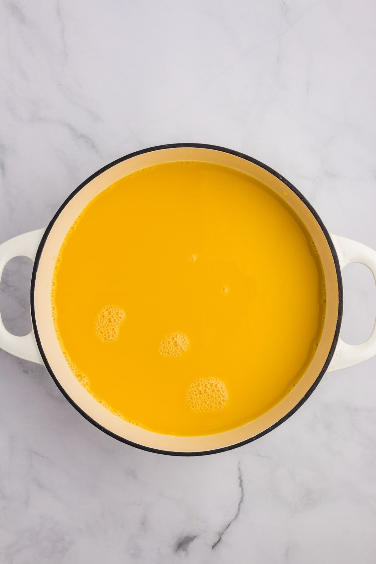 A large pot filled with orange juice.