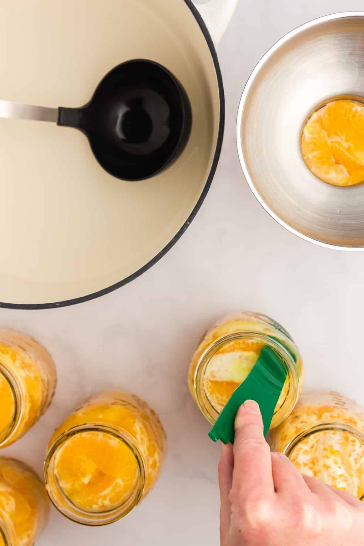 Using a de-bubbler to remove air bubbles from a canning jar.