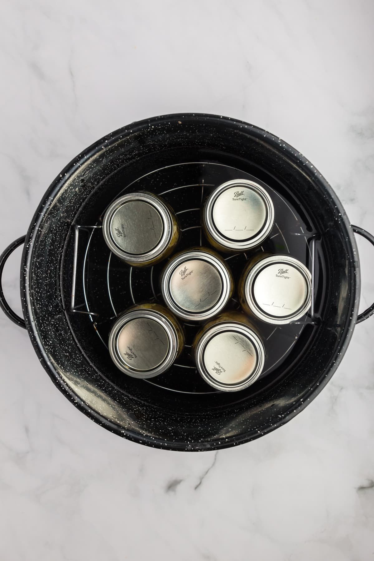 Pint jars in a water bath canner.