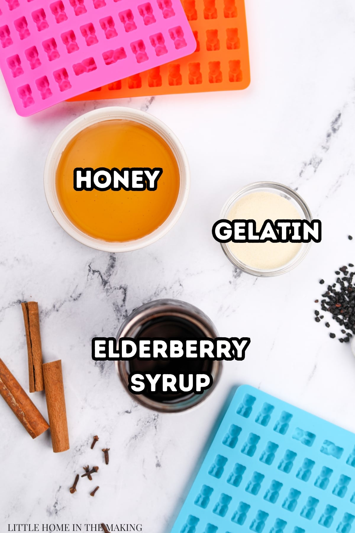 The ingredients needed to make elderberry gummies: elderberry syrup, gelatin, and honey.