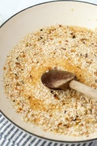 Stirring risotto with a wooden spoon.