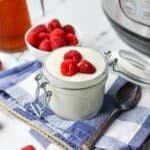 Yogurt topped with fresh raspberries.