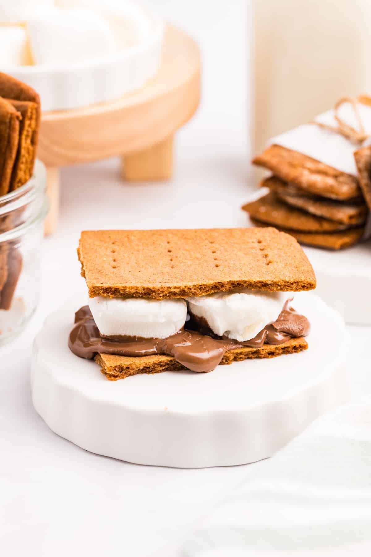 A s'more featuring homemade graham crackers, marshmallows, and chocolate.