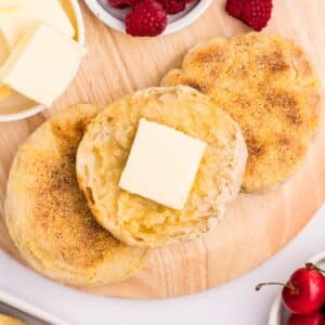 Split english muffins topped with a pat of butter.