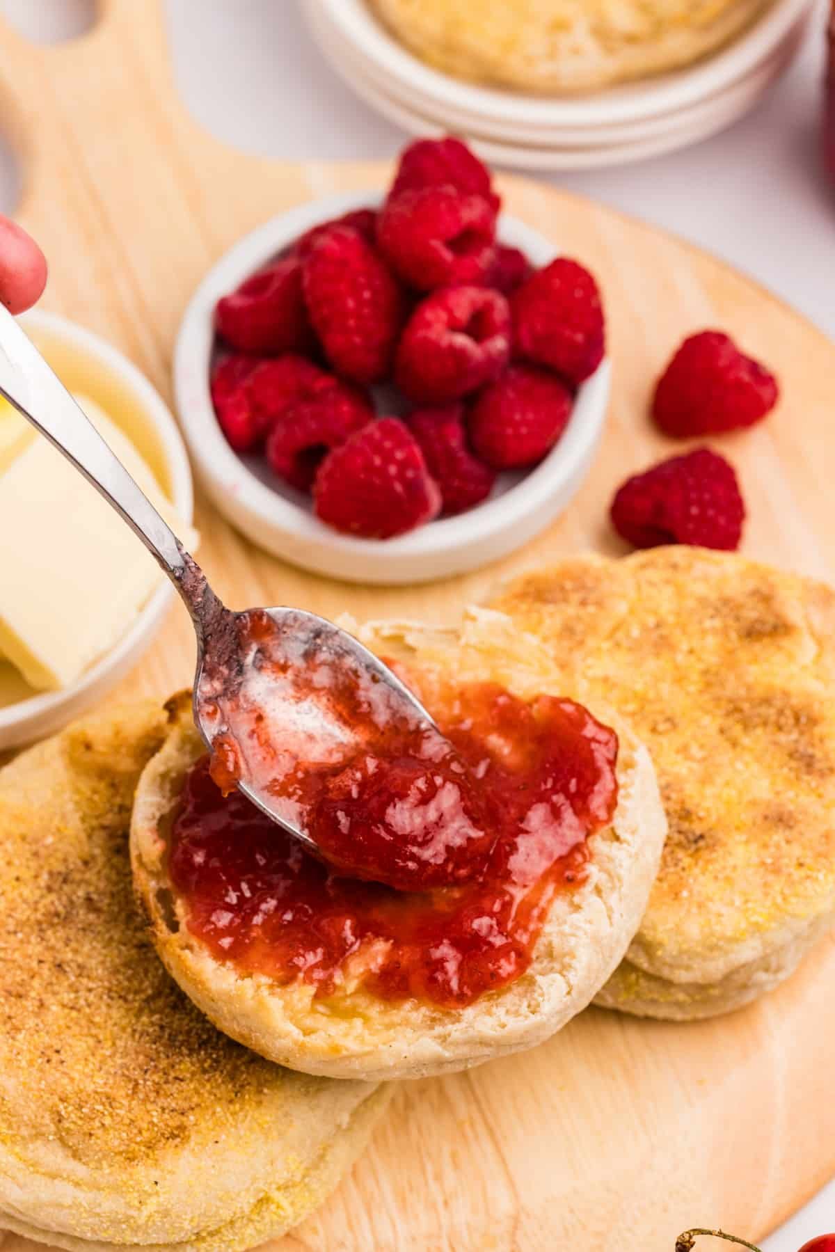 Spreading jam on a piece of bread.