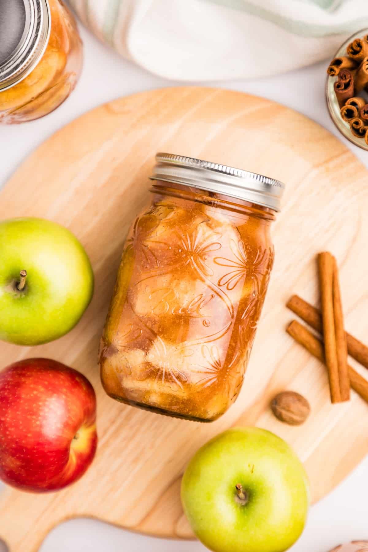 A jar of apple pie filling laying on its side.