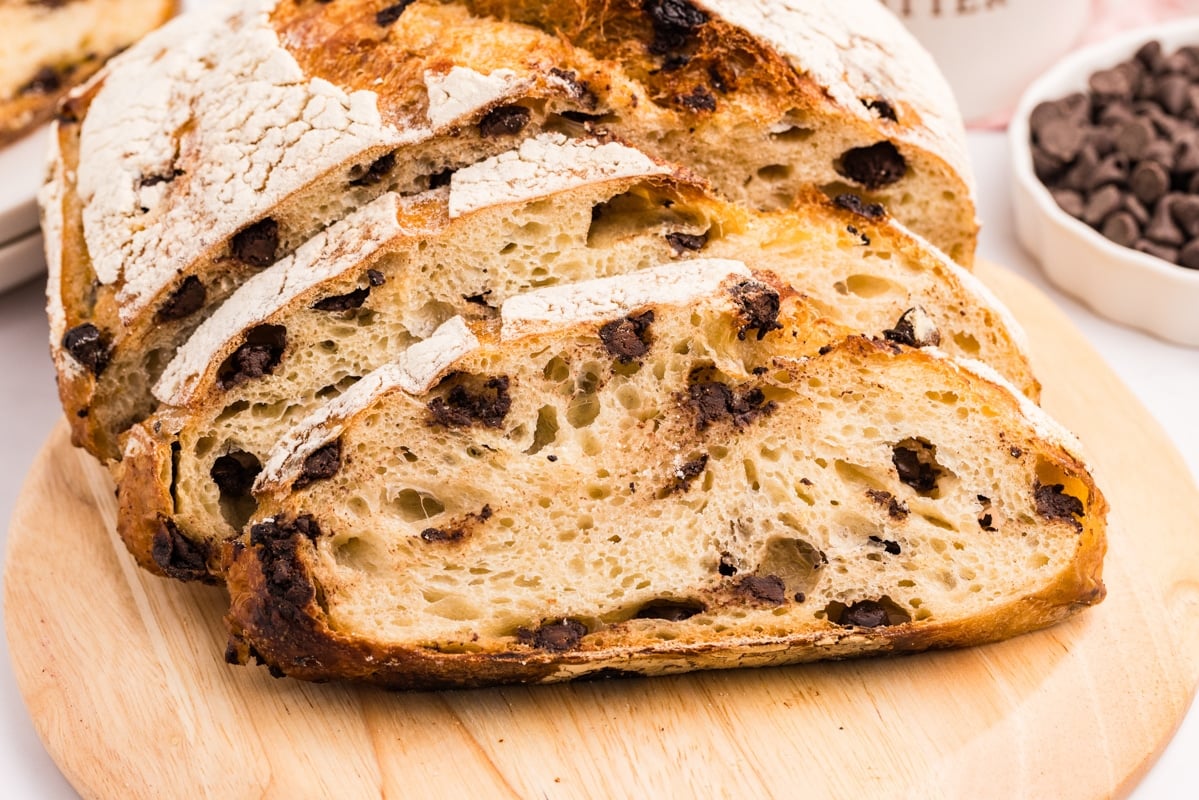A round boule of sourdough bread that has been baked with the addition of chocolate chips.