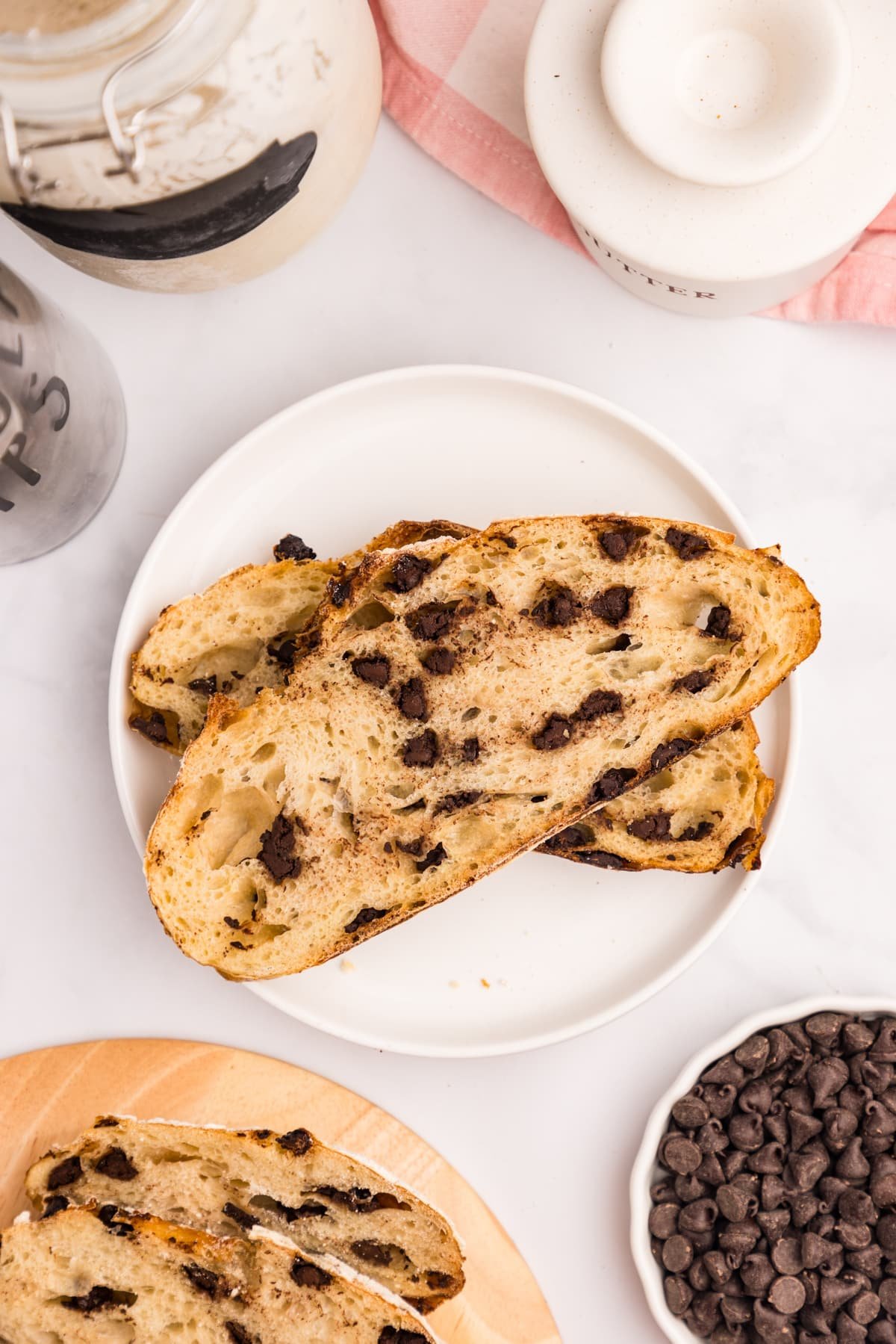 Two slices of sourdough chocolate chip bread on a white plate.