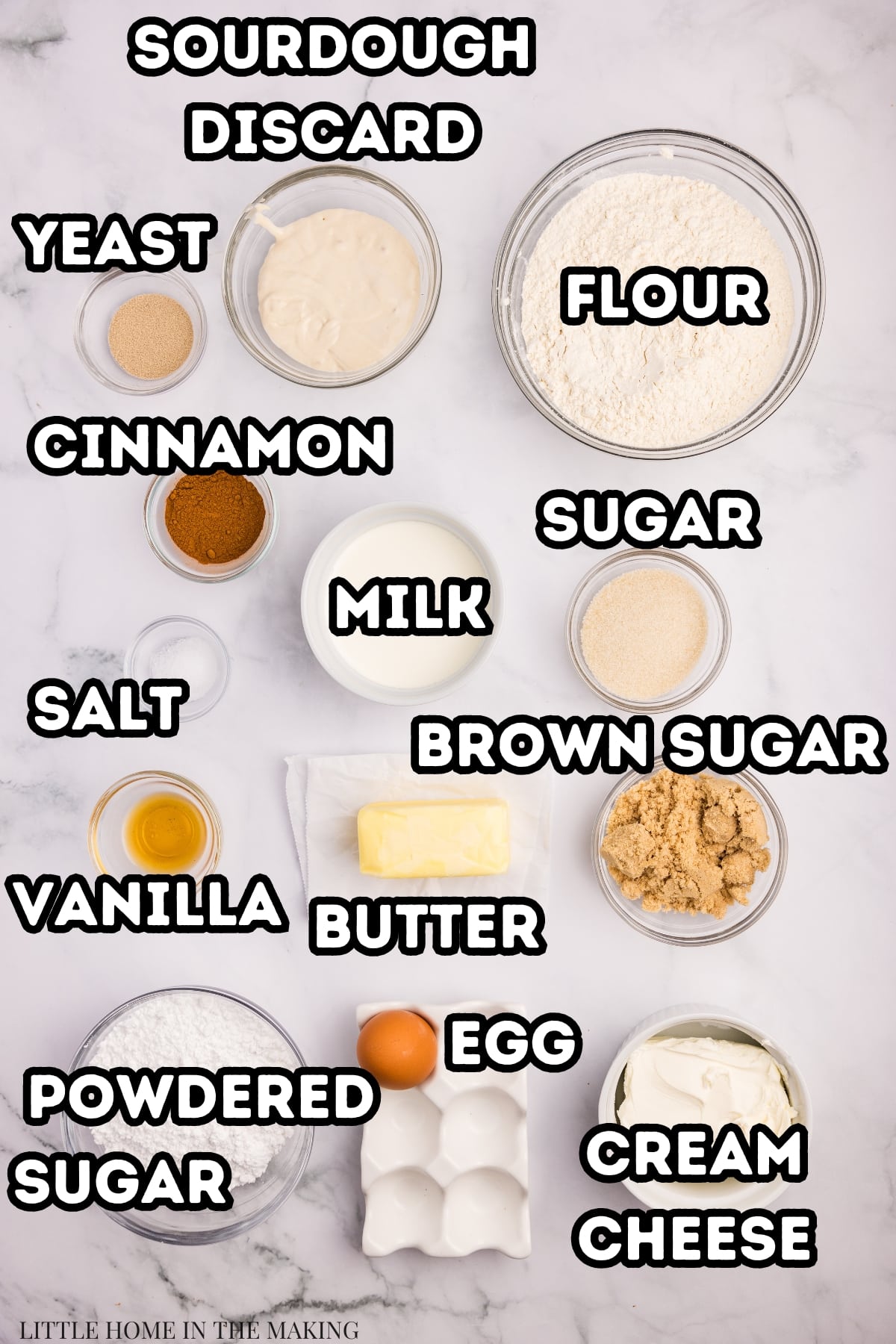 The ingredients needed to make sourdough cinnamon rolls, including starter, flour, milk, sugar, brown sugar, and cinnamon.