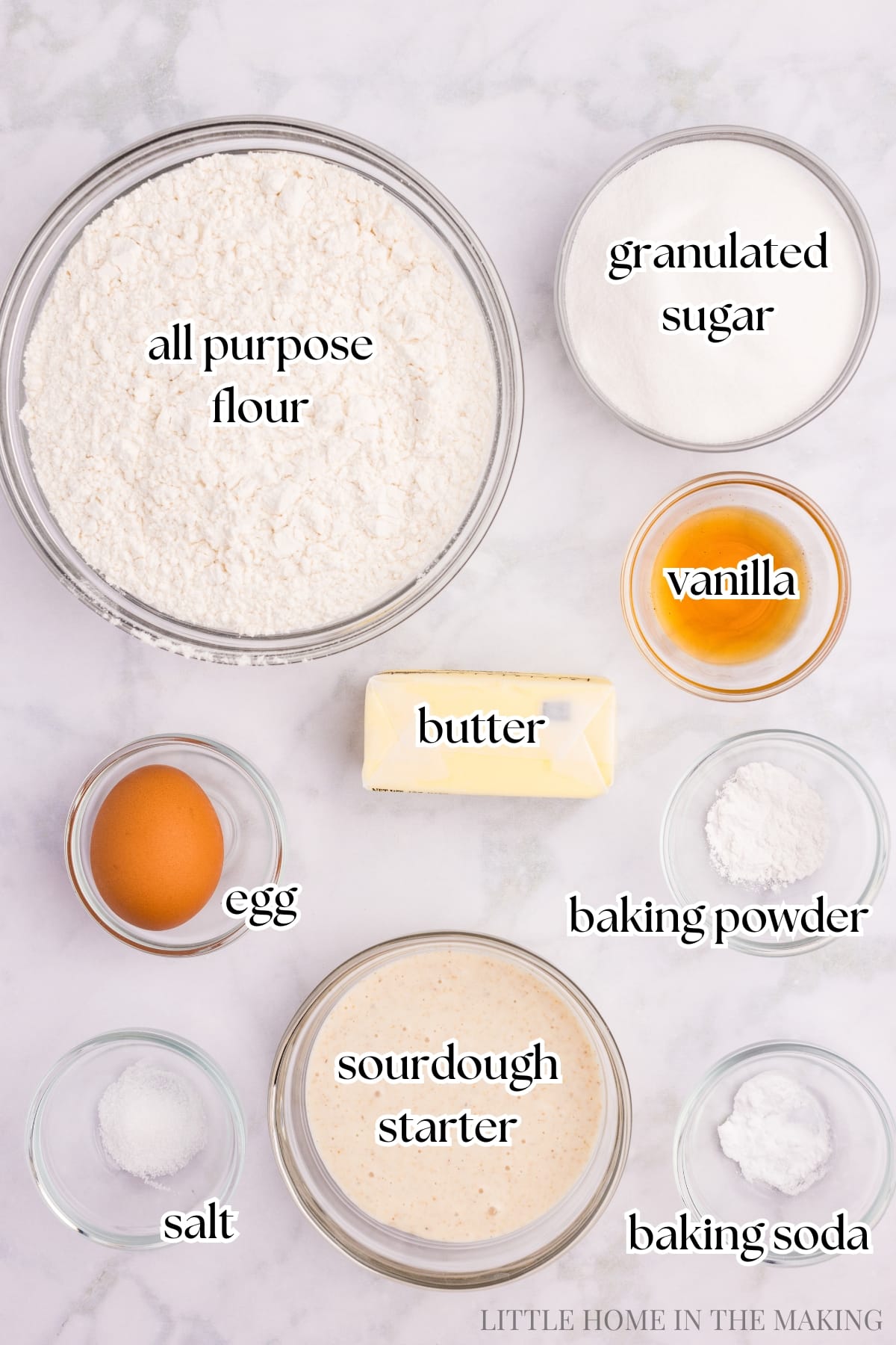 The ingredients needed to make sourdough sugar cookies, including flour, butter, and egg.