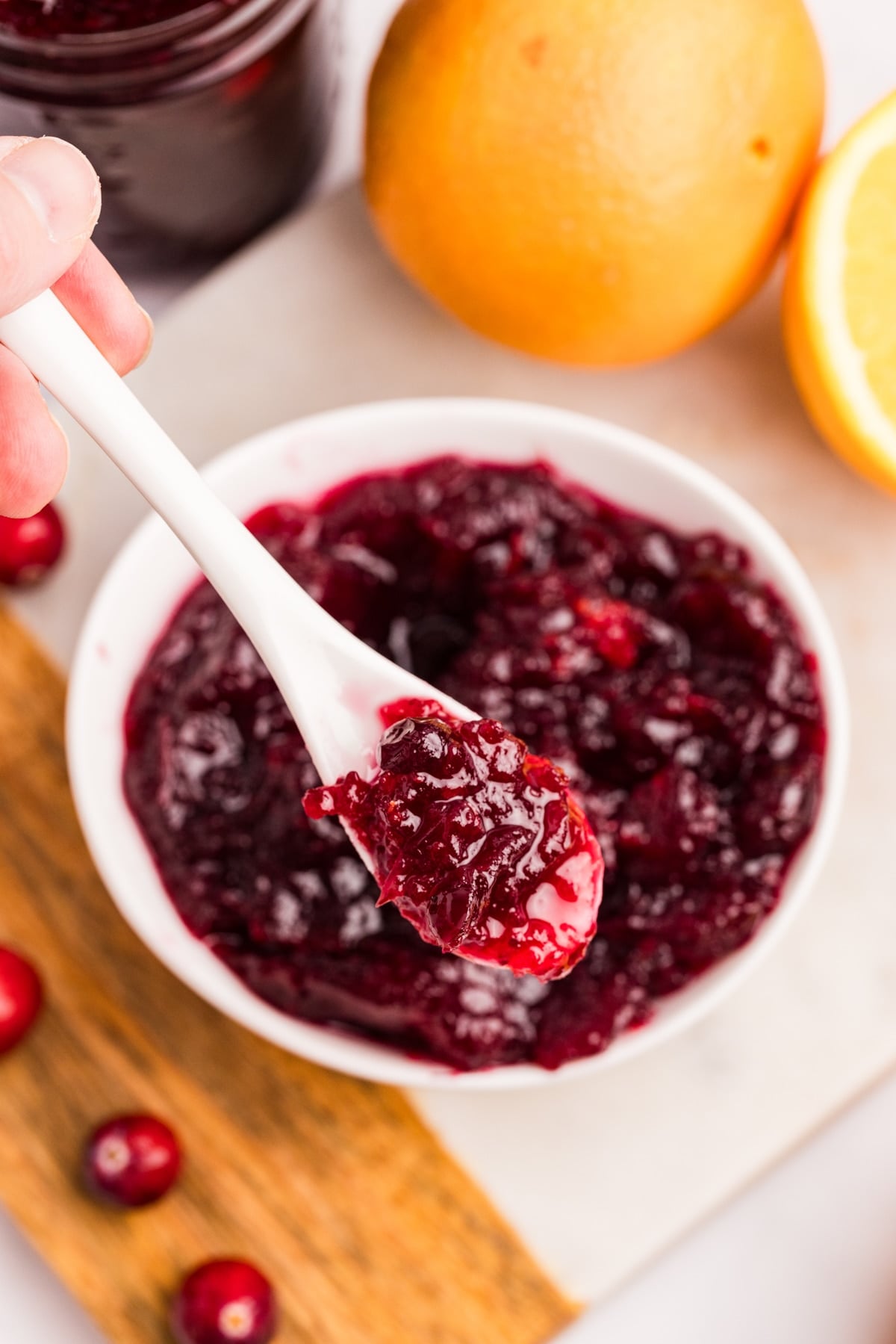 Canning Whole Berry Cranberry Sauce A bowl of cranberry sauce, with a spoon showing the whole berry texture.
