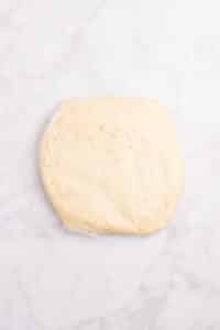 A dough wrapped in several layers of plastic wrap.