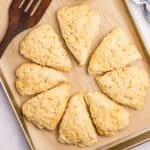 Sourdough scones shaped as wedges on a baking sheet.