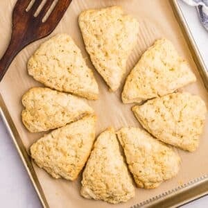 Sourdough scones shaped as wedges on a baking sheet.