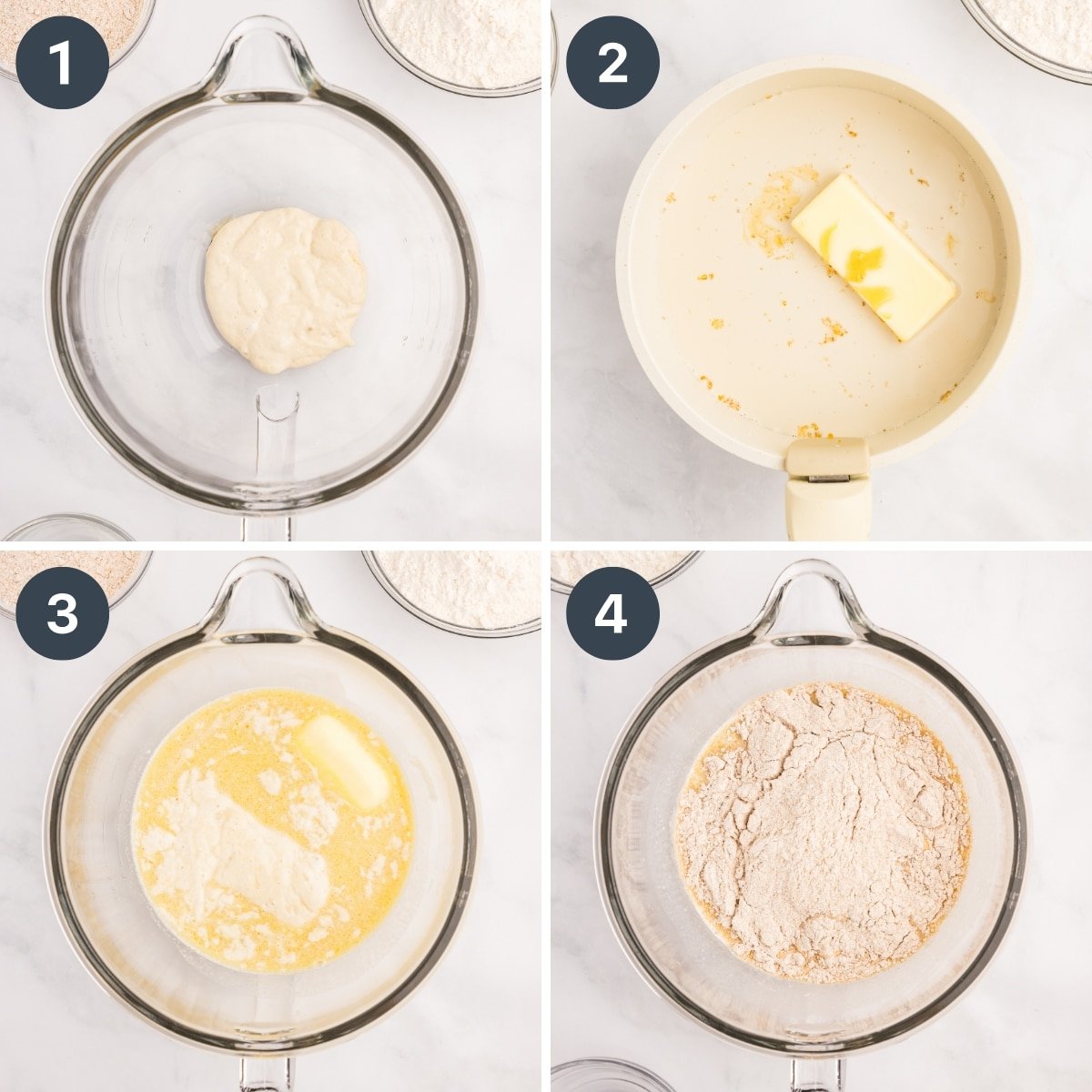 Adding whole wheat flour to a warm milk mixture in the bowl of a stand mixer.