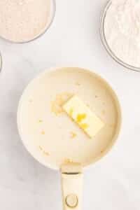 Warming milk and butter in a saucepan.