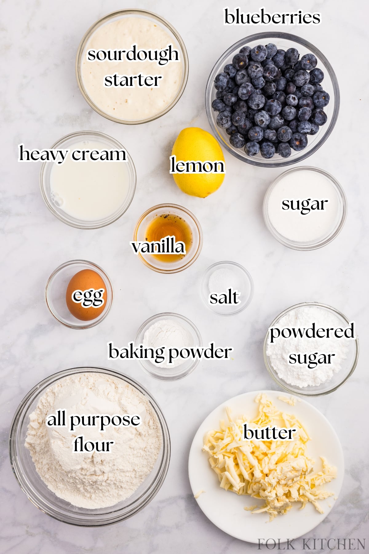 The ingredients needed to make blueberry sourdough scones, including fresh berries, sourdough starter, etc.